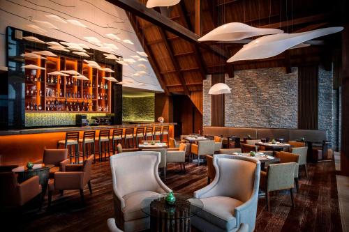 a restaurant with tables and chairs and a bar at Park Chalet, Shahdag, Autograph Collection in Shahdag