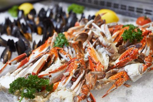a plate of seafood with crabs and other foods at Le Méridien Kuala Lumpur in Kuala Lumpur