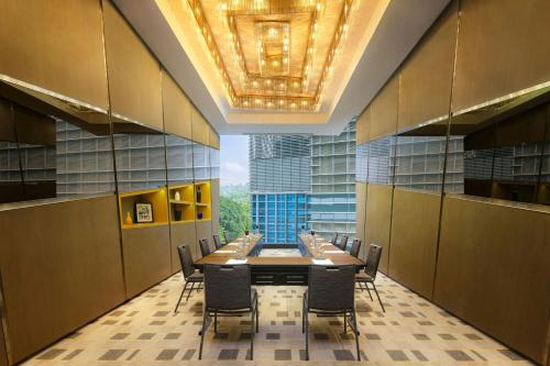 a conference room with a long table and chairs at Le Méridien Kuala Lumpur in Kuala Lumpur