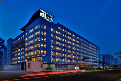 a building with a sign on the top of it at Aloft New Delhi Aerocity in New Delhi