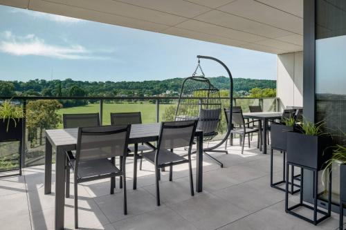 a patio with tables and chairs on a balcony at AC Hotel by Marriott Krakow in Kraków
