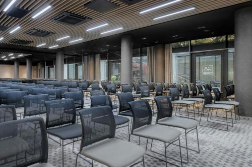 a conference room with chairs and tables and windows at AC Hotel by Marriott Krakow in Kraków