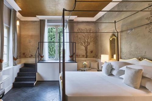 a bedroom with a bed and a staircase at Grotta Giusti Thermal Spa Resort Tuscany, Autograph Collection in Monsummano