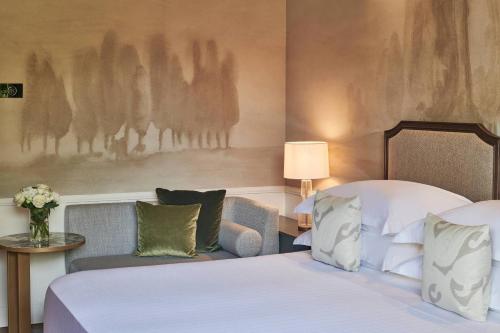 a hotel room with a bed and a couch at Grotta Giusti Thermal Spa Resort Tuscany, Autograph Collection in Monsummano