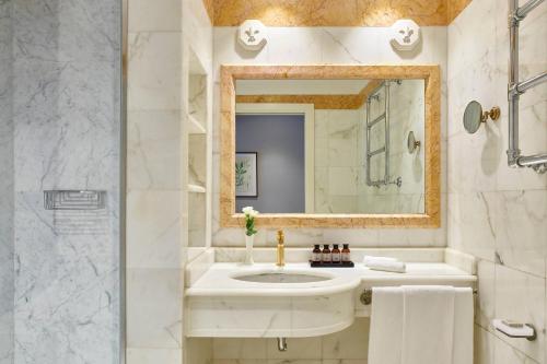 a bathroom with a sink and a mirror at Grotta Giusti Thermal Spa Resort Tuscany, Autograph Collection in Monsummano
