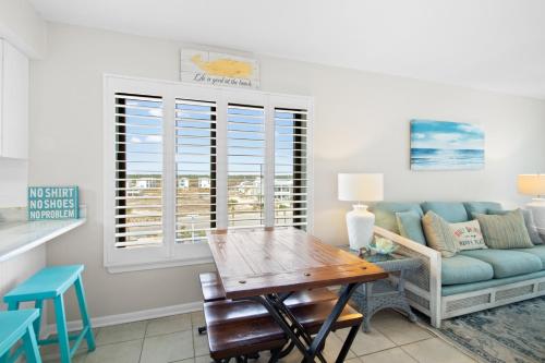 a living room with a couch and a table at Island Sunrise 469 in Gulf Shores