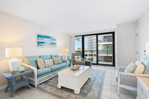 a living room with a couch and a table at Island Sunrise 469 in Gulf Shores