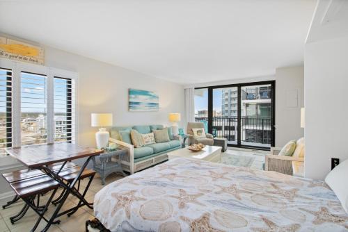 a bedroom with a bed and a living room at Island Sunrise 469 in Gulf Shores