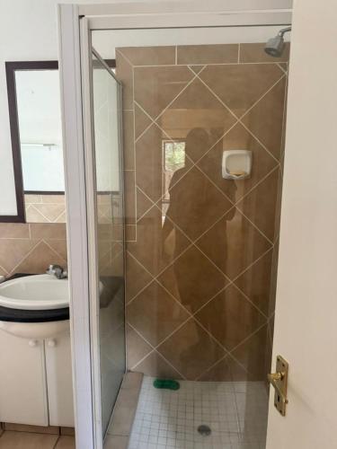 a shower with a glass door in a bathroom at The palace in Sandton