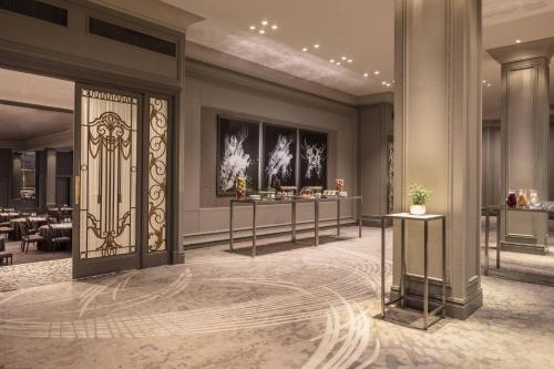 a rendering of a lobby with a door and tables at JW Marriott Grosvenor House London in London