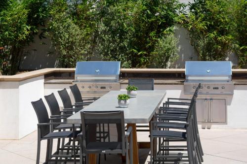 a table and chairs with laptops on top of it at Residence Inn by Marriott Los Angeles Pasadena/Old Town in Pasadena