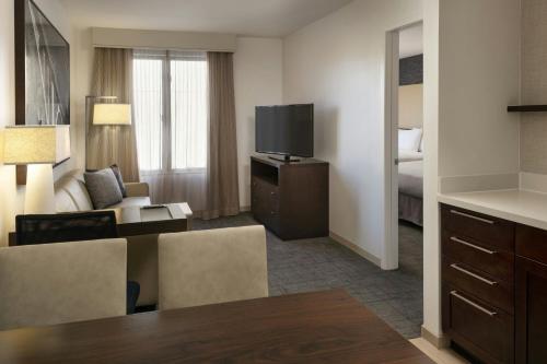 a hotel room with a living area and a television at Residence Inn by Marriott Los Angeles Pasadena/Old Town in Pasadena