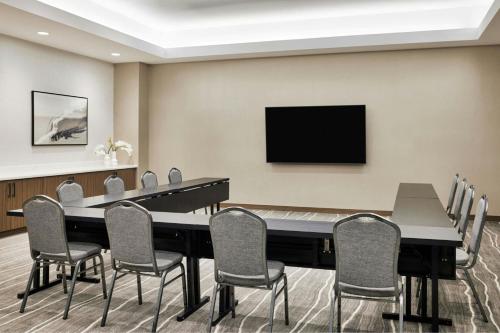 a conference room with a large table and chairs at AC Hotel By Marriott Dallas By The Galleria in Dallas
