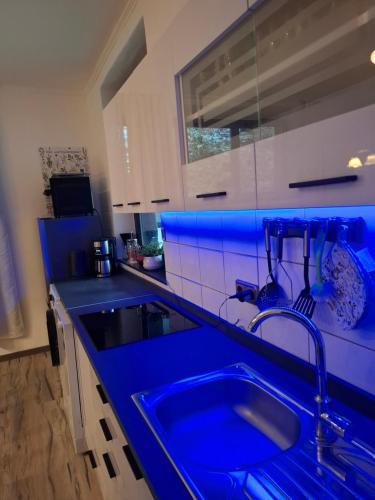 a kitchen with a blue counter top with a sink at Ferienzimmer by Riela im ehemaligem Hotel Schöneck in Schönecken