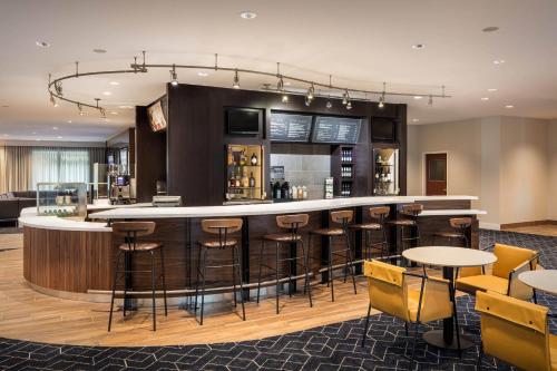 a bar in a hotel with chairs and tables at Courtyard by Marriott Anaheim Resort/Convention Center in Anaheim