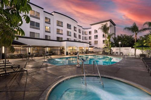 an image of a hotel with a swimming pool at Courtyard by Marriott Anaheim Resort/Convention Center in Anaheim