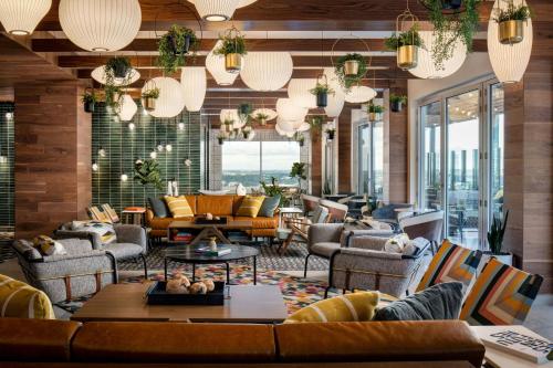 a lobby with couches and tables and windows at Le Meridien Fort Worth Downtown in Fort Worth