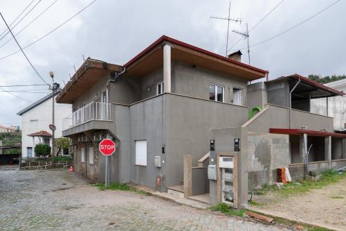 a building with a stop sign in front of it at Casa Petisqueira 88-Paredes-Oporto in Rebordosa