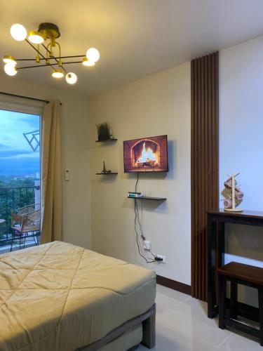a bedroom with a bed and a fireplace on the wall at Z and R Haven in Lapu Lapu City