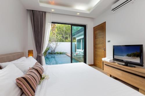 מיטה או מיטות בחדר ב-La Ville Phuket Pool Villa
