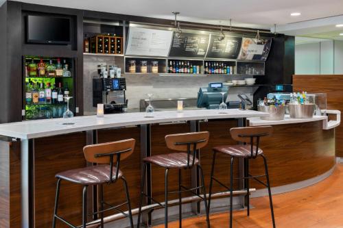 a bar in a restaurant with stools at Courtyard by Marriott Danbury in Danbury