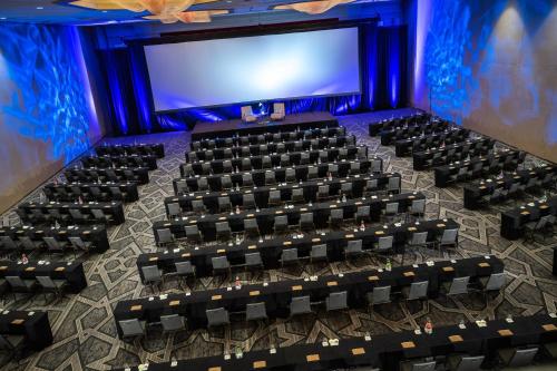 an auditorium with rows of chairs in front of a screen at Renaissance Dallas Addison in Addison