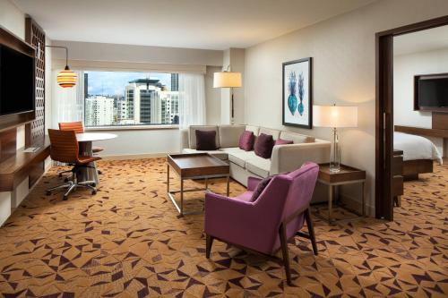 a hotel room with a couch and a bed at Sheraton Grand Seattle in Seattle