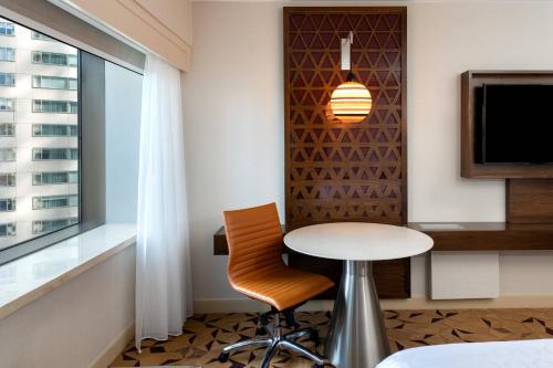 a table and chair in a room with a window at Sheraton Grand Seattle in Seattle