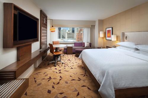 a hotel room with a bed and a flat screen tv at Sheraton Grand Seattle in Seattle