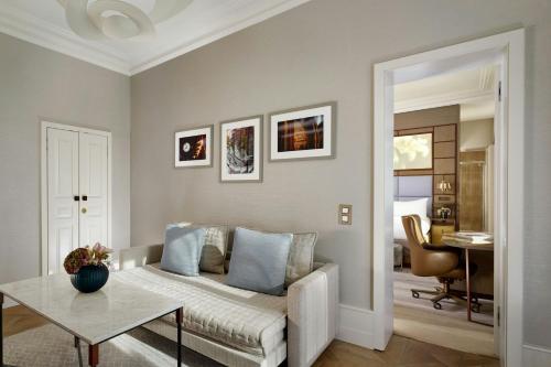 a living room with a couch and a table at The Ritz-Carlton Hotel de la Paix, Geneva in Geneva