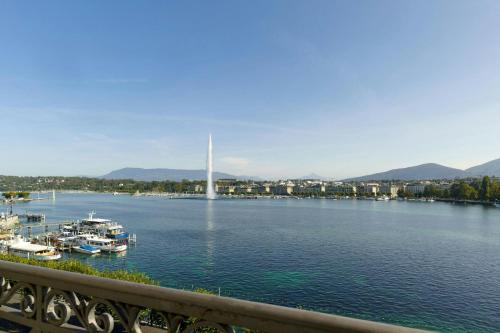 a view of a river with boats in the water at The Ritz-Carlton Hotel de la Paix, Geneva in Geneva