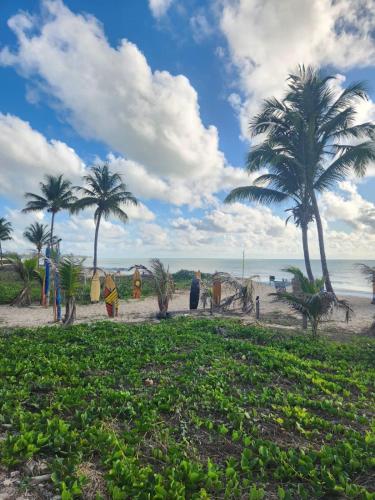 a group of people standing on a beach with palm trees at Apartamento Flat, Incrível, 250 M da Praia in Cabedelo