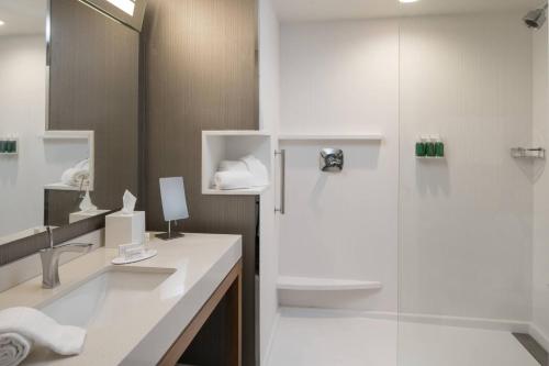 a bathroom with a sink and a shower at Courtyard by Marriott Lafayette South in Lafayette