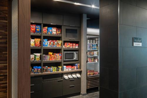 a walk in pantry with a microwave and food at Courtyard by Marriott Lafayette South in Lafayette