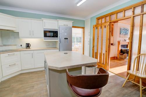 a kitchen with white cabinets and a counter top at Mevagh House in Carrigart