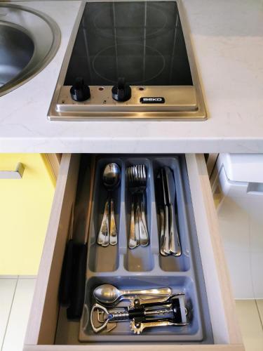 a drawer in a kitchen with silver utensils at Apartment Ennio in Povlja