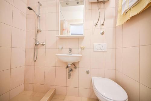 a bathroom with a toilet and a sink at Apartment Ennio in Povlja