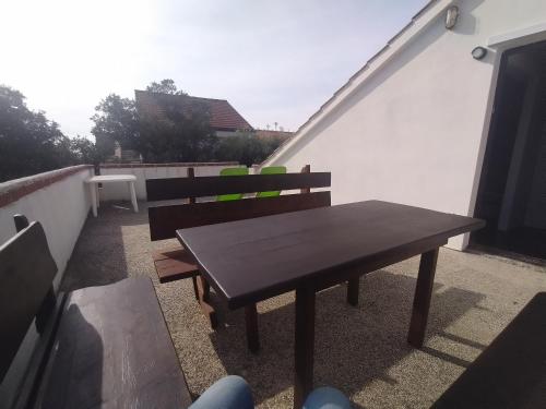 a wooden table and two chairs on a balcony at Villa Terraca in Mandre