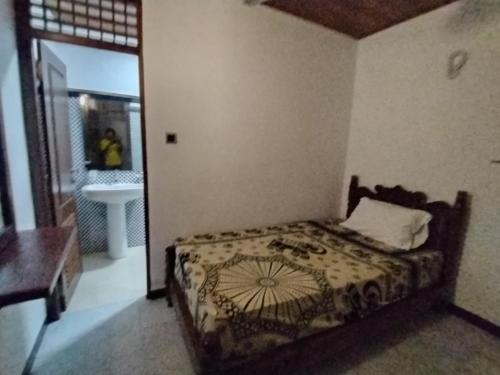 a bedroom with a bed and a bathroom with a sink at Little Beach in Induruwa