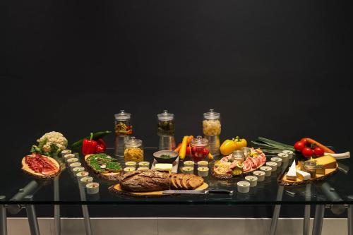 a table topped with different types of food at Le Méridien Vienna in Vienna