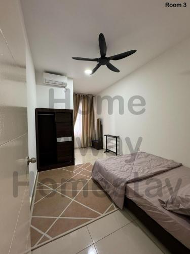 a bedroom with a bed and a ceiling fan at Home Away Homestay in Siliau
