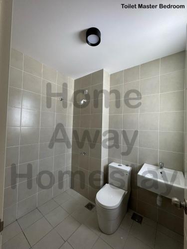 a bathroom with a toilet and a sink at Home Away Homestay in Siliau
