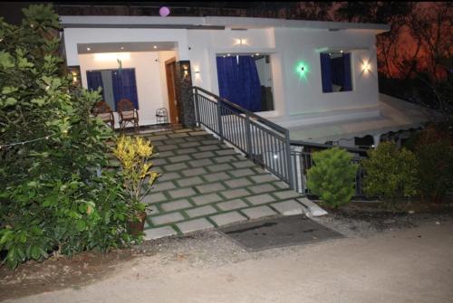 a house with a staircase leading to a home at WinterHome homestay in Munnar