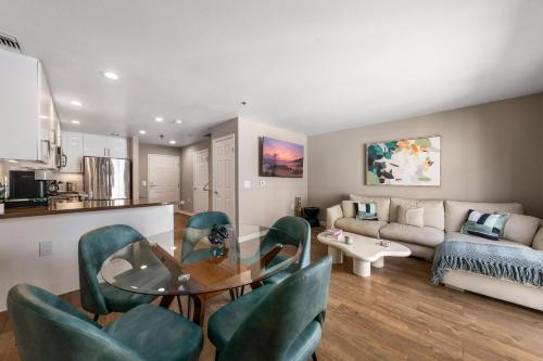 a living room with a glass table and green chairs at Carnelian Calm-Pool BBQ Rooftop Walk to the Beach in Los Angeles