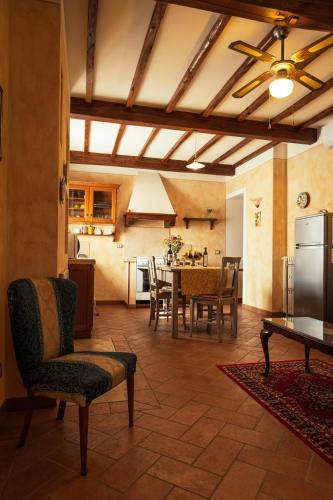 a kitchen and dining room with a table and refrigerator at Agriturismo Casal Gheriglio in Lucignano