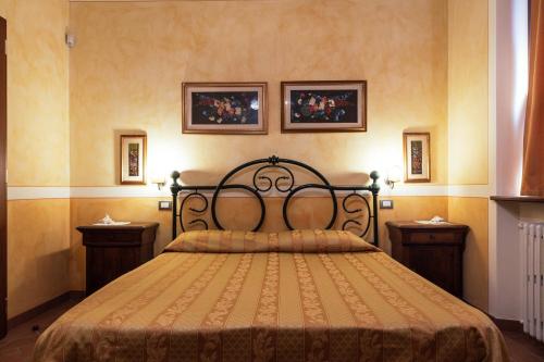 a bedroom with a large bed with two night stands at Agriturismo Casal Gheriglio in Lucignano
