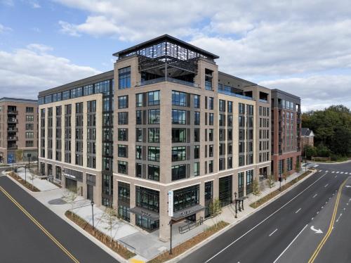an architectural rendering of a building on a city street at Hyatt House Raleigh Downtown/Seaboard Station in Raleigh