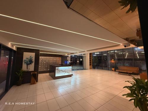 a lobby of a building with a bench and a table at Vivacity Jazz Suites Kuching by REA Homestay in Kuching