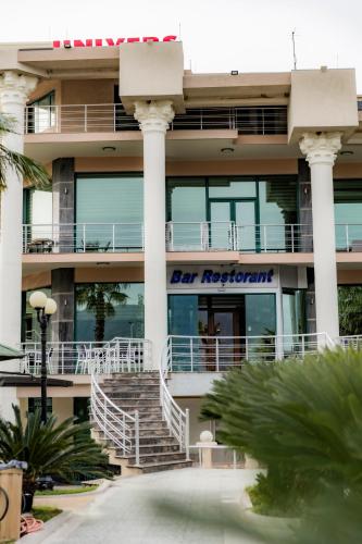 a building with a sign for the detroit hospital at Hotel Univers Laç in Fushë-Milot