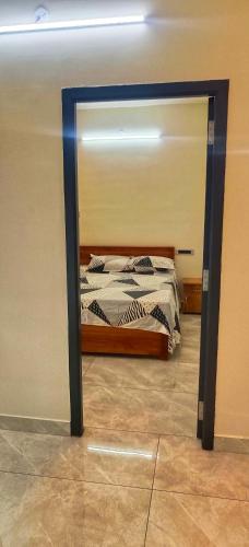 a bedroom with a bed with a mirror in it at Shivalaya's 2BHK Service Apartment Near Adiyogi & Siruvani in Alāndurai